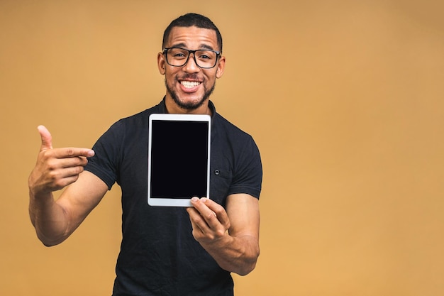 Laughing Young African American black man Holding a Touch Pad Tablet PC