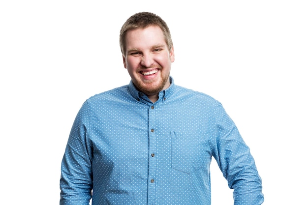 Laughing young man with brown hair and beard in a blue shirt Success positive and happiness White background