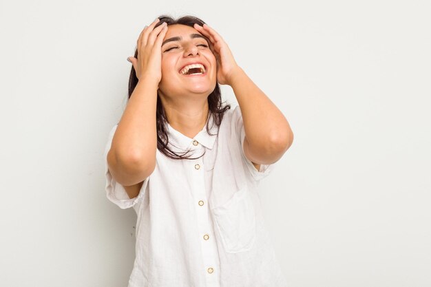 Laughs joyfully keeping hands on head Happiness concept