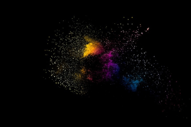 Launched multicolored powder on black background.Color powder explosion.Colorful dust splashing.