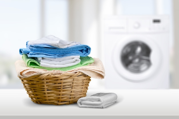 Laundry basket on blurred background of modern washing machine