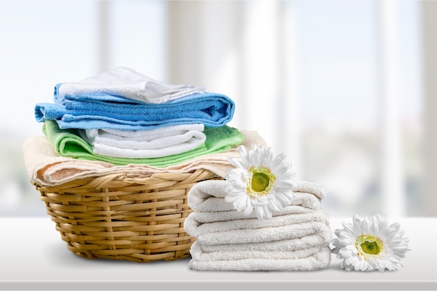 Laundry Basket with colorful towels on background