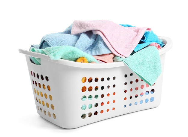 Laundry basket with dirty towels on white background