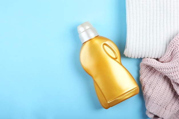 Laundry detergent bottles and clothes on the table household chemicals