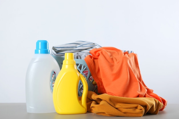 Laundry detergent bottles and clothes on the table household chemicals