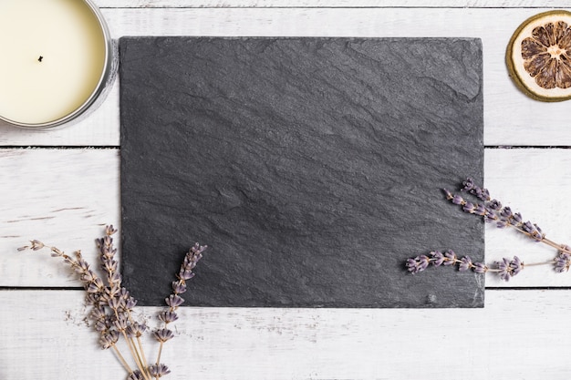 Lavender on black graphite board upon white rustic wooden table. 