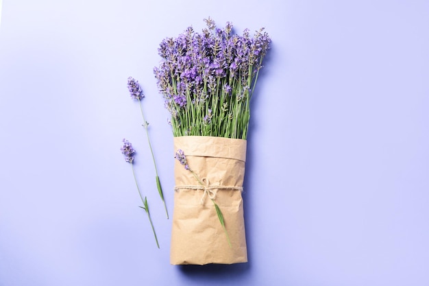 Lavender in craft paper on violet background