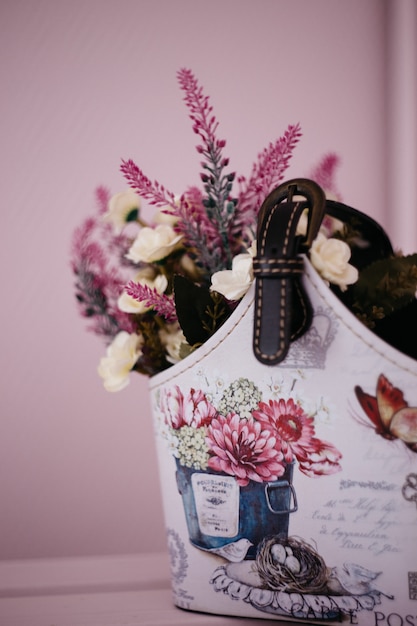 lavender flowers in a homemade basket on a pink background, home decor