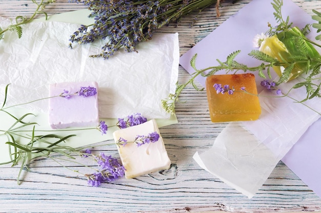 Lavender flowers soap oils and tinctures on a wooden background natural ingredients