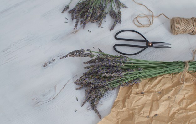 Lavender harvesting Lavender bouquet on white wooden  Aromatherapy  Top view Copy space French Provence style