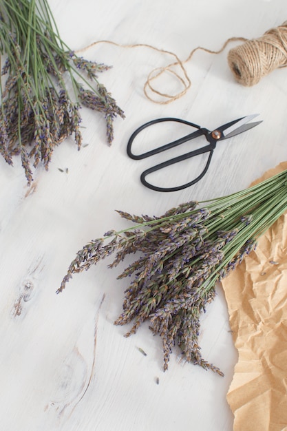 Lavender harvesting Lavender bouquet on white wooden  Aromatherapy  Top view Copy space French Provence style