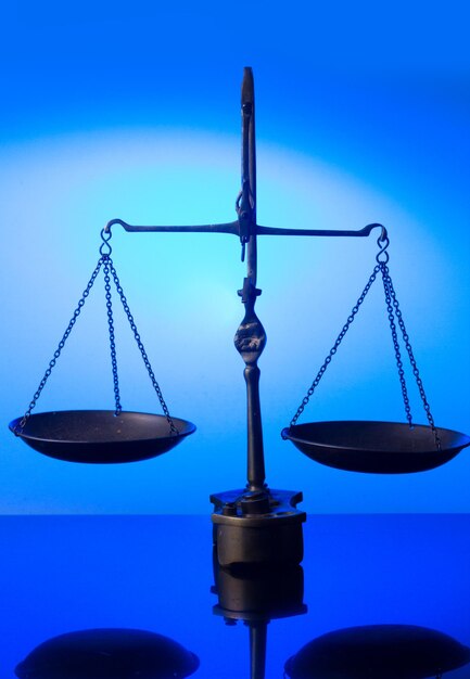 Law antique scales on blue futuristic background