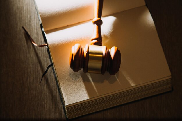 Law books and scales of justice on desk in library of law firm jurisprudence legal education concept