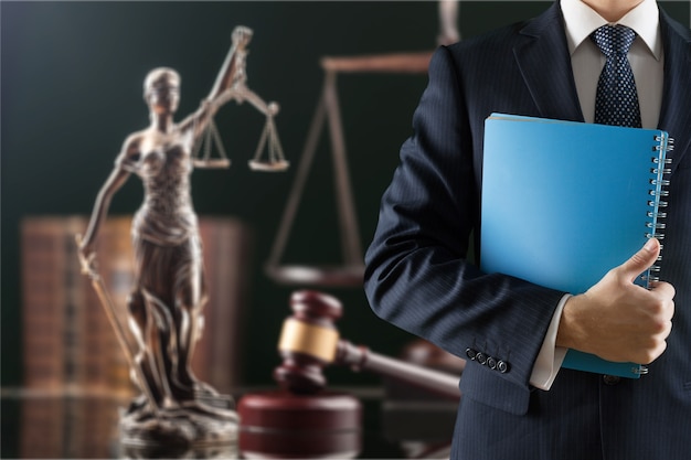 Law and justice concept. Man with notebook on justice background