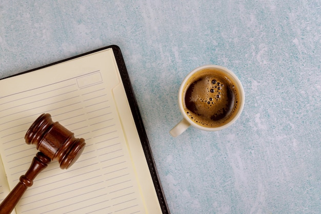 Photo law justice office desk table with supplies, coffee cup on a judge law gavel