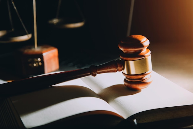 law legal technology concept judge gavel on computer with scales of justice on desk of lawyer