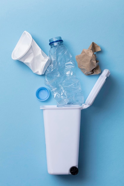 Lay flat of trash bin with a plastic bottle and waste paper Recycling concept