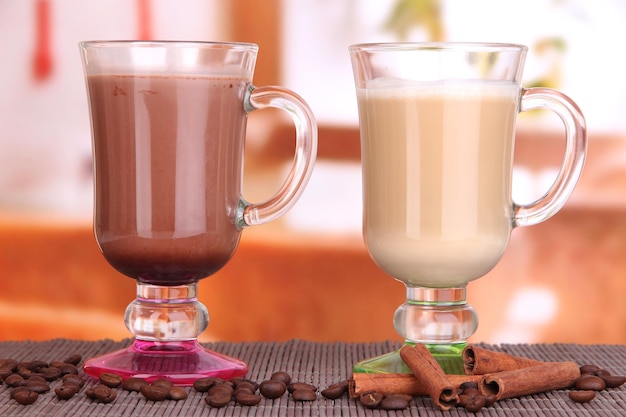 Layered coffee in glass on table on bright background