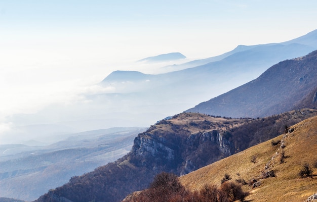 Layered mountains in a haze in the sun. Sunrise in the Crimean mountains.