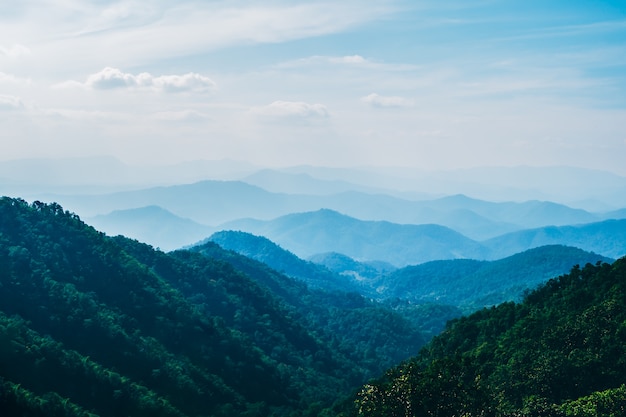 Layers of the green natural mountains landscape and blue sky