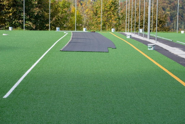 Laying of synthetic grass