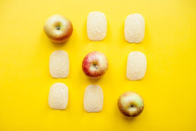 A layout of chips and apples in the form of a tictactoe game weight loss and diet concept