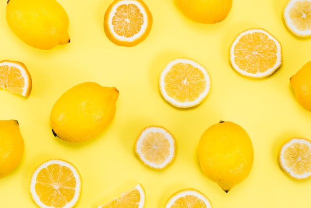 Layout of citrus fruits on yellow background