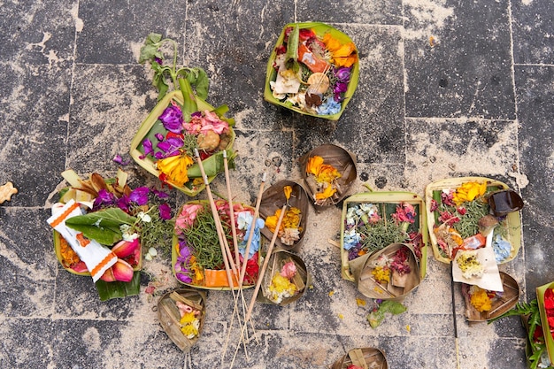 The layout on the ground of traditional offerings for the spirits on the island of Bali