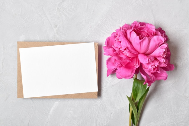 The layout is made of a kraft envelope and the color of a peony on a gray background