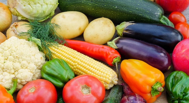 Layout made with of various vegetables and fruits on a table in a garden outdoor