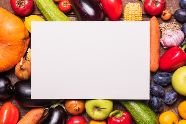 Layout with various vegetables and fruits and white paper card 