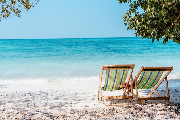 Lazy chair on the sea beach and bright blue sky on a board day light with light yellow fine sand