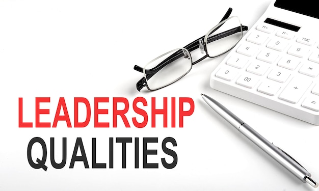 LEADERSHIP QUALITIES Concept Calculatorpen and glasses on white background