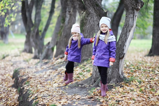 Leaf fall in the park Children for a walk in the autumn park Family Fall Happiness