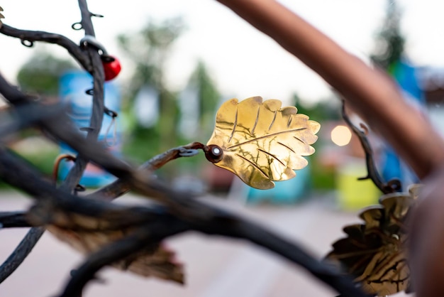 Leaf on a tree made of gold on an artificial metal tree Decor element in the park