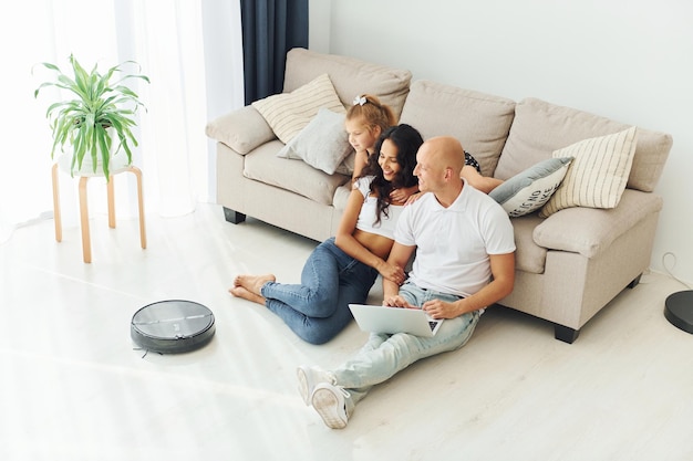 Leaning on the sofa Cheerful couple is together indoors