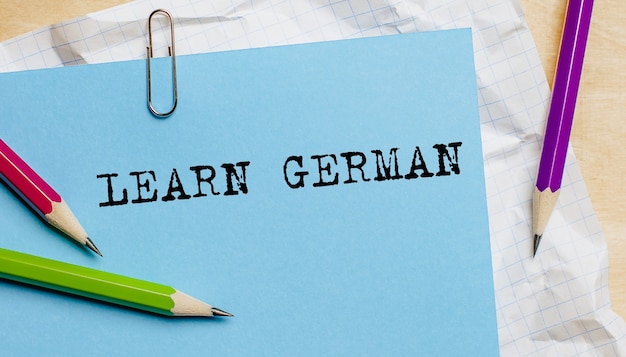 Learn German text written on a paper with pencils in office