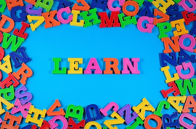 Learn written by plastic colorful letters on a blue background