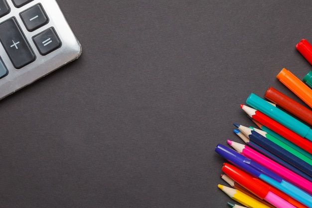 Learning never ends. Inspirational design with school supplies on top of blackboard texture