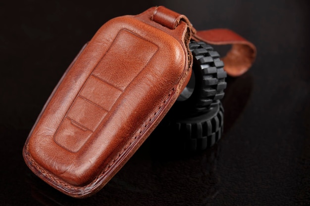 Leather case for car keys on a black background