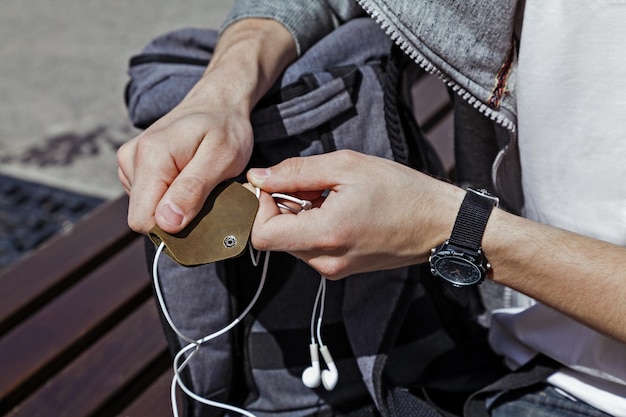 Leather case for headphones in mens hands closeup