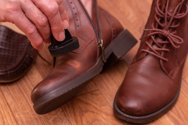 Leather shoe care. Applying shoe polish to brown shoes.