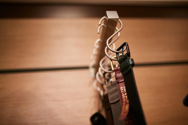 leather straps on hooks on a shelf in a store