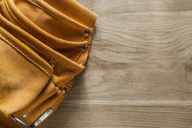 Leather tool belt on wood board