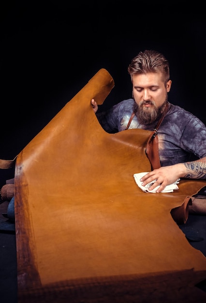 Leather Worker cutting leather outlines for his new production