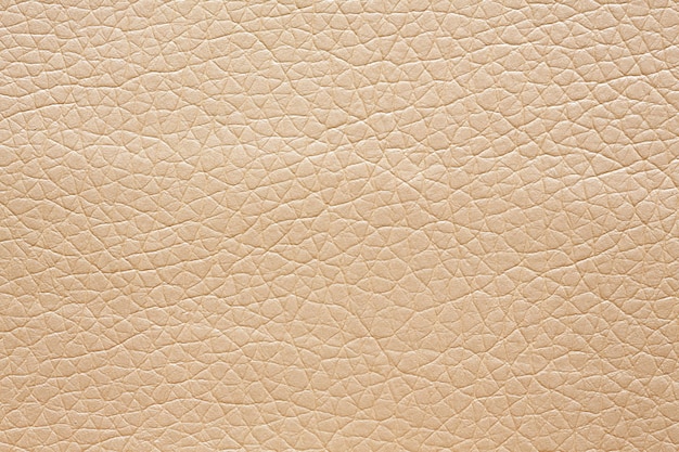 Photo leatherette background in gentle beige colour on macro