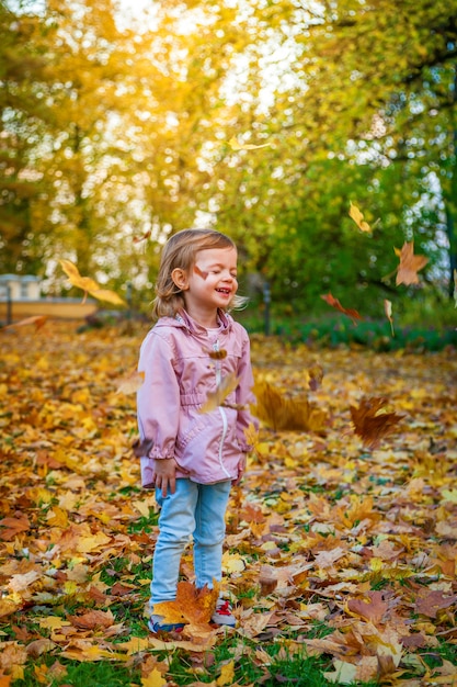 Leaves are falling on the little girl