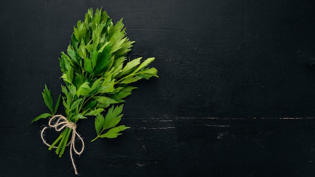 The leaves of celery On a wooden background Top view Copy space