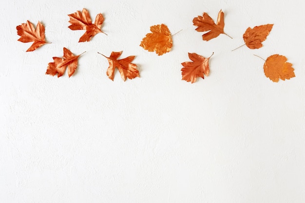 Leaves stained with gold paint on white