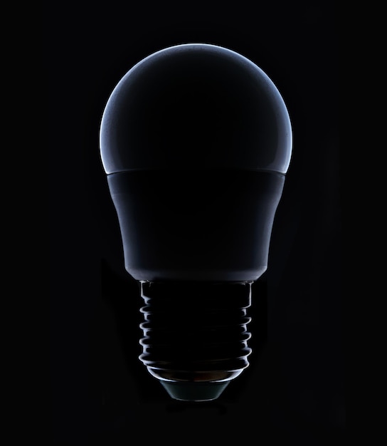 Led colored light bulb on a dark background closeup